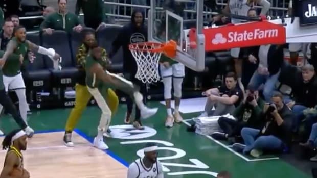 Thanasis Antetokounmpo is held back by a teammate after a hard foul on his brother Giannis